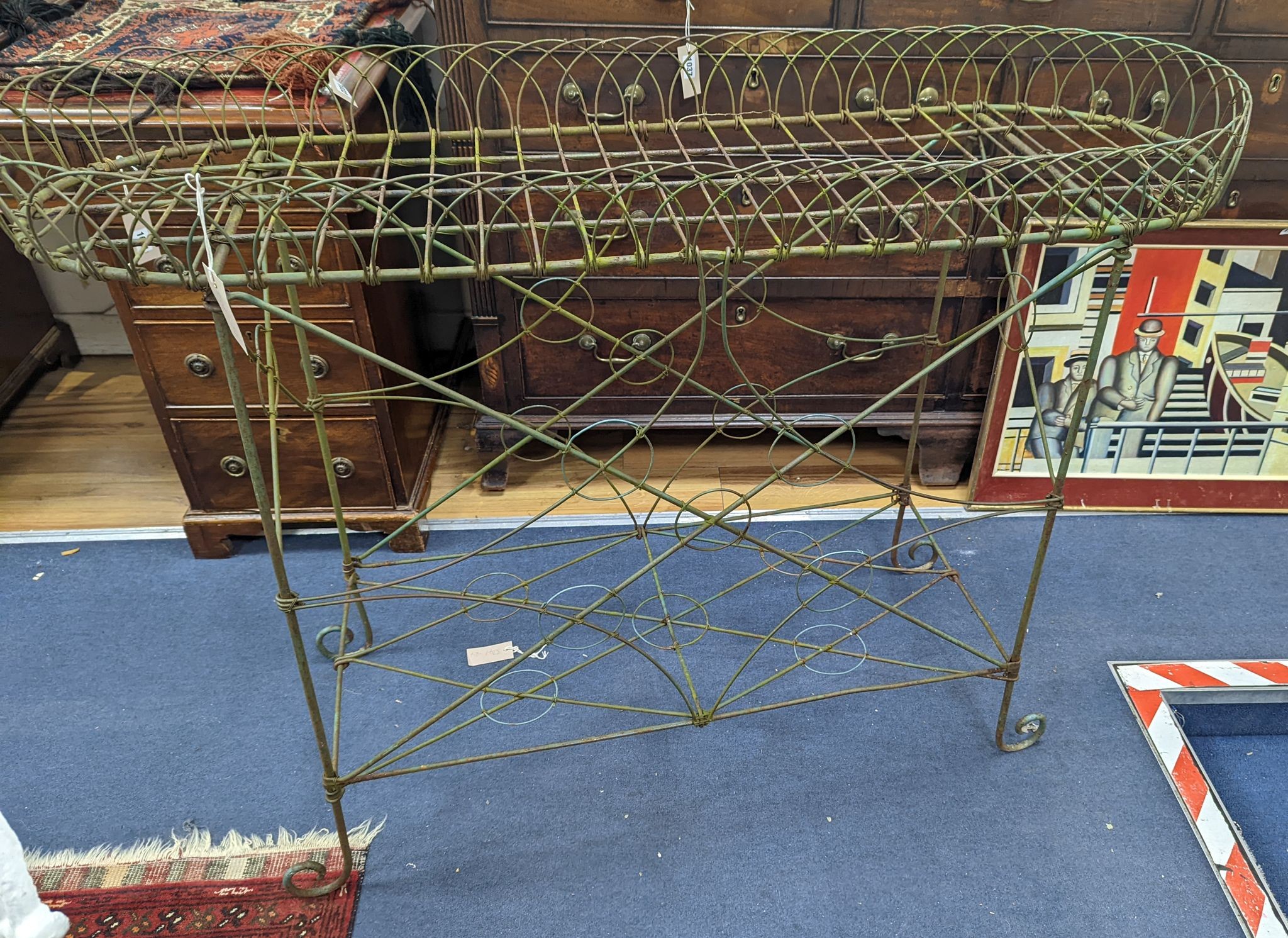 A wirework pot stand, width 122cm, depth 43cm, height 90cm